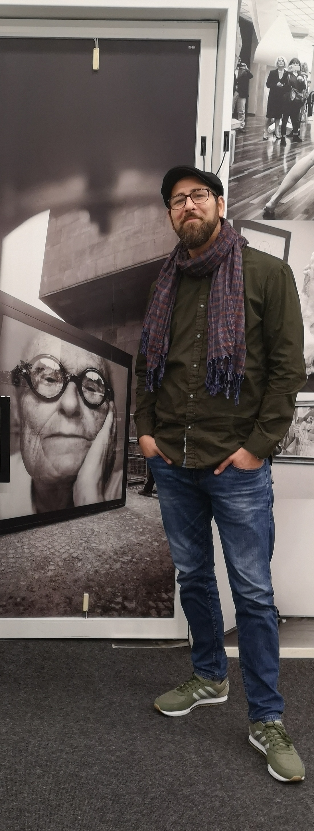 image of a man standing beside a picture